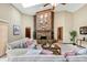 Spacious living room with a brick fireplace, skylights, and comfortable furnishings at 1039 Whispering Cv, Casselberry, FL 32707