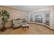 Cozy living room with floral wallpaper, vintage sofa, and bay window at 1039 Whispering Cv, Casselberry, FL 32707