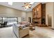 Cozy living room with a brick fireplace and sliding glass doors leading to a pool at 1039 Whispering Cv, Casselberry, FL 32707