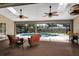 This spacious patio offers ceiling fans, comfortable seating, and a great view of the private pool at 1039 Whispering Cv, Casselberry, FL 32707
