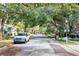 Scenic street view showcasing mature trees and well-maintained homes at 1039 Whispering Cv, Casselberry, FL 32707
