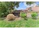 Green backyard with a screened-in porch for enjoying the outdoors in comfort at 1107 Monroe Ave, St Cloud, FL 34769