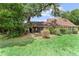 Lush backyard with a covered patio and mature trees providing ample shade at 1107 Monroe Ave, St Cloud, FL 34769