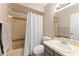 Bathroom with neutral colors, a shower with a curtain, and a classic vanity for everyday convenience at 1107 Monroe Ave, St Cloud, FL 34769