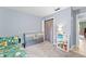 Bedroom showcasing light blue walls, a comfortable bed, and -friendly décor for a cozy ambiance at 1107 Monroe Ave, St Cloud, FL 34769