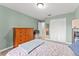 Bedroom featuring light green walls, natural light, and calming decor, creating a serene space at 1107 Monroe Ave, St Cloud, FL 34769