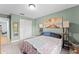 Bedroom featuring light green walls, natural light, and calming decor, creating a serene space at 1107 Monroe Ave, St Cloud, FL 34769