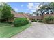 Inviting home exterior with a well-kept lawn, paved driveway, and mature landscaping at 1107 Monroe Ave, St Cloud, FL 34769