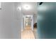 Hallway featuring neutral paint and tile flooring, leading towards additional rooms in the home at 1107 Monroe Ave, St Cloud, FL 34769
