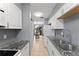 Functional kitchen layout with white cabinets and tile flooring at 1107 Monroe Ave, St Cloud, FL 34769