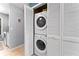 This laundry room features a stacked washer and dryer unit tucked away in a closet behind louvered doors at 1107 Monroe Ave, St Cloud, FL 34769