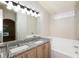 Bright bathroom features double sinks with granite counters and a soaking tub at 111 Spring Ridge Dr, Debary, FL 32713