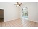 Large bright bedroom with large sliding glass door to pool and neutral tile flooring at 111 Spring Ridge Dr, Debary, FL 32713