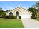 Charming single-story home with a well-manicured lawn, mature trees, and a two-car garage at 111 Spring Ridge Dr, Debary, FL 32713
