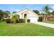 Charming single-story home with a well-manicured lawn, mature trees, and a two-car garage at 111 Spring Ridge Dr, Debary, FL 32713