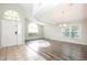 Open-concept living room featuring hard wood floors, a high ceiling, and natural light at 111 Spring Ridge Dr, Debary, FL 32713
