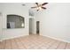 Open living area with tile floors, a ceiling fan, and a clear view into the kitchen area at 111 Spring Ridge Dr, Debary, FL 32713