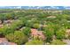 An aerial view of the community surrounded by lush greenery with a city skyline in the distance at 1111 Salerno Ct # Ge, Orlando, FL 32806