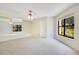 Bright bedroom with a large window, ceiling fan, and neutral decor, offering a comfortable and serene atmosphere at 1111 Salerno Ct # Ge, Orlando, FL 32806