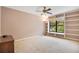 Bright bedroom with a built-in shelving, large window, and neutral decor, offering a comfortable living space at 1111 Salerno Ct # Ge, Orlando, FL 32806
