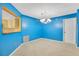 Dining area with blue accent wall and view to the kitchen at 1111 Salerno Ct # Ge, Orlando, FL 32806