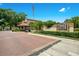 Community entrance featuring manicured landscaping, signage, and a secure gatehouse at 1111 Salerno Ct # Ge, Orlando, FL 32806
