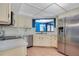 Well-equipped kitchen featuring stainless steel appliances, ample counter space, and a convenient pass-through window at 1111 Salerno Ct # Ge, Orlando, FL 32806