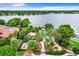 Expansive lake view featuring lush greenery, a pool, and neighborhood homes under a beautiful sky at 1111 Salerno Ct # Ge, Orlando, FL 32806