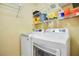 Functional laundry room with washer, dryer, and wire shelving for storage at 1111 Salerno Ct # Ge, Orlando, FL 32806