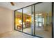 An expansive view of the open living room beyond the glass sliding doors at 1111 Salerno Ct # Ge, Orlando, FL 32806
