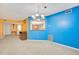 Bright living room featuring unique wall colors, chandelier and open layout at 1111 Salerno Ct # Ge, Orlando, FL 32806