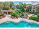 Beautiful community pool area with jacuzzi, waterfall feature, and many chairs for relaxing by the pool at 1111 Salerno Ct # Ge, Orlando, FL 32806