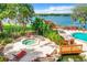 Gorgeous pool and spa overlooking the lake, surrounded by lush landscaping and lounge chairs at 1111 Salerno Ct # Ge, Orlando, FL 32806