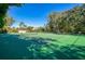 A well-maintained tennis court surrounded by lush landscaping and mature trees at 1111 Salerno Ct # Ge, Orlando, FL 32806