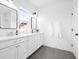 Modern bathroom featuring double sinks, white cabinets, and tiled flooring, offering a clean and stylish space at 1120 Parma Cir, Lake Mary, FL 32746