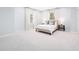 Bright bedroom with white carpet, a cozy bed, and natural light streaming through the large windows at 1120 Parma Cir, Lake Mary, FL 32746