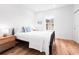 Bright bedroom with hardwood floors, a decorative bed frame, and a sunlit window at 1120 Parma Cir, Lake Mary, FL 32746