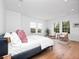 Spacious bedroom with hardwood floors, large windows, and neutral decor, providing a serene retreat at 1120 Parma Cir, Lake Mary, FL 32746