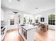 Well-lit open concept kitchen with a center island, adjacent to the dining area for easy entertaining at 1120 Parma Cir, Lake Mary, FL 32746