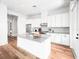 Elegant kitchen with modern cabinetry, stainless appliances, a central island and hardwood flooring at 1120 Parma Cir, Lake Mary, FL 32746