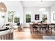 Cozy open concept living and dining area with large windows and stylish seating arrangements at 1120 Parma Cir, Lake Mary, FL 32746