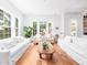 Expansive living room featuring hardwood floors, comfortable seating, and natural light from large windows at 1120 Parma Cir, Lake Mary, FL 32746