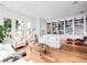 Spacious living room with a built-in bookshelf, hardwood floors and well-lit with natural light at 1120 Parma Cir, Lake Mary, FL 32746