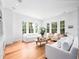 Bright living room featuring hardwood floors, recessed lighting, and multiple windows, offering a view of the outdoors at 1120 Parma Cir, Lake Mary, FL 32746