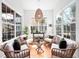 Bright and airy sitting area featuring ample windows and comfortable wicker furniture for relaxation at 1120 Parma Cir, Lake Mary, FL 32746