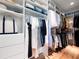 Organized walk-in closet with custom shelving, hanging rods, and ample space for clothing storage at 1120 Parma Cir, Lake Mary, FL 32746