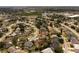 Sprawling neighborhood aerial view showcasing various home styles, lush landscaping, and community layout with a nearby lake at 11705 Binfield Ct, Orlando, FL 32837