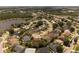 Scenic aerial view of the community featuring well-maintained homes and a serene lake at 11705 Binfield Ct, Orlando, FL 32837