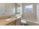 Standard bathroom features a bath tub, toilet, and vanity with a granite countertop at 11705 Binfield Ct, Orlando, FL 32837