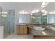 Bathroom featuring a double vanity, marble countertops, and a glass-enclosed shower with marble tiling at 11705 Binfield Ct, Orlando, FL 32837